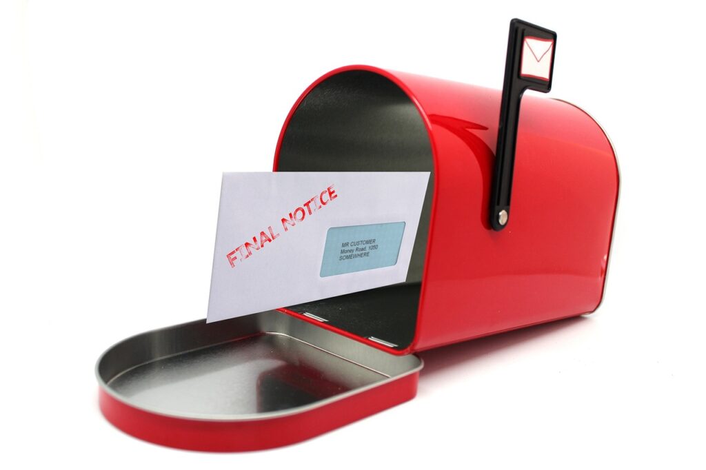 A red mailbox with its door open, containing a single envelope labeled "FINAL NOTICE.
